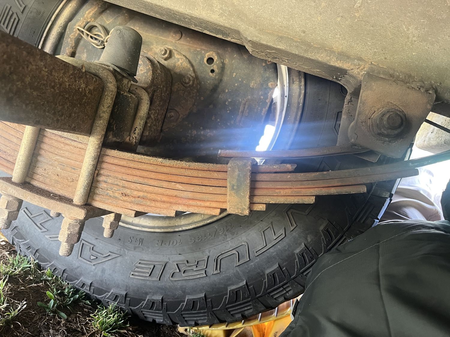 Close up of a broken leaf spring under a caravan, photographed during the repair